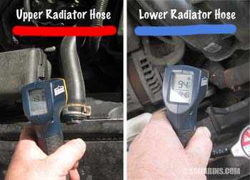 Mechanic measures radiator hose temperature with an infrared thermometer